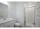 Clean bathroom with a white vanity, toilet, and glass-enclosed shower at 6871 Adalene Ln, Carmel, IN 46033