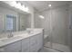 Elegant bathroom with a glass-enclosed shower, double vanity, and modern fixtures at 6871 Adalene Ln, Carmel, IN 46033