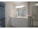 Bright bathroom with a double vanity, large mirror, and modern lighting at 6871 Adalene Ln, Carmel, IN 46033