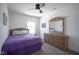 Cozy bedroom with natural wood furniture and a plush purple comforter at 6871 Adalene Ln, Carmel, IN 46033