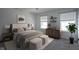 Well-lit bedroom with neutral tones, a comfortable bed, and modern furnishings at 6871 Adalene Ln, Carmel, IN 46033