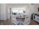 Inviting dining area with rustic table, hardwood floors, and views into the living spaces at 6871 Adalene Ln, Carmel, IN 46033