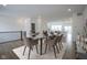 Dining room with modern table and chairs, open to kitchen and living area at 6871 Adalene Ln, Carmel, IN 46033