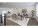 Dining room with table set, open to the kitchen, offers a stylish space for meals and gatherings at 6871 Adalene Ln, Carmel, IN 46033