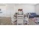 Bright dining area featuring a wooden table, white chairs, and stylish decor on wood floors and a decorative rug at 6871 Adalene Ln, Carmel, IN 46033