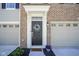 Inviting front entrance with decorative wreath, elegant trim, and 'wipe your paws' welcome mat at 6871 Adalene Ln, Carmel, IN 46033