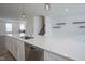 Kitchen island with sink and dishwasher in this open-concept space with stairs and white walls at 6871 Adalene Ln, Carmel, IN 46033