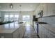 Modern kitchen featuring white cabinets, stainless steel appliances, and a large island with seating at 6871 Adalene Ln, Carmel, IN 46033