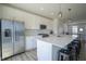 Modern kitchen featuring white cabinets, stainless steel appliances and island with barstool seating at 6871 Adalene Ln, Carmel, IN 46033