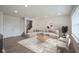 Bright living room features neutral decor, wood floors, and large windows at 6871 Adalene Ln, Carmel, IN 46033