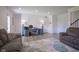 Large living room area with a comfortable sofa, a desk area, and multiple doors at 6871 Adalene Ln, Carmel, IN 46033