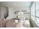 Bright living room with modern decor, neutral palette, and staircase at 6871 Adalene Ln, Carmel, IN 46033