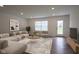 Sunlit living room with neutral palette, wood-look floors, and modern furnishings at 6871 Adalene Ln, Carmel, IN 46033