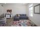 Cozy living space with a pullout sofa, stylish decor, and a decorative rug illuminated by natural light at 6871 Adalene Ln, Carmel, IN 46033