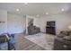 Spacious living room with hardwood floors, a plush sofa, and a television at 6871 Adalene Ln, Carmel, IN 46033