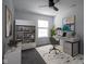 Well-lit home office featuring a modern desk, shelving, and a comfortable chair at 6871 Adalene Ln, Carmel, IN 46033
