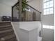 Carpeted stairway with a black metal railing and a plant, leading to a bright, open living space at 6871 Adalene Ln, Carmel, IN 46033