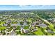 An aerial view highlights an upscale neighborhood with tree-lined streets, well-kept lawns, and serene ponds at 7116 Trail Ridge Ln, Indianapolis, IN 46259