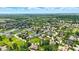 An aerial perspective captures a serene neighborhood featuring lush green spaces and tranquil ponds, offering a harmonious blend of nature and luxury at 7116 Trail Ridge Ln, Indianapolis, IN 46259