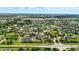 An aerial view of an upscale neighborhood complete with tranquil ponds and beautiful homes nestled among lush greenery at 7116 Trail Ridge Ln, Indianapolis, IN 46259