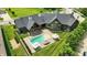 Stunning aerial view of the house with a pool, covered patio, and lush green lawn at 7116 Trail Ridge Ln, Indianapolis, IN 46259