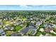 An expansive aerial view captures a residential community with lush landscaping, tranquil ponds, and beautiful homes at 7116 Trail Ridge Ln, Indianapolis, IN 46259