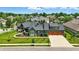Expansive aerial view of home showcasing landscaping, three-car garage and neighborhood at 7116 Trail Ridge Ln, Indianapolis, IN 46259