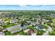 A beautiful aerial view showcases upscale homes, lush greenery, and tranquil ponds in a well-manicured community at 7116 Trail Ridge Ln, Indianapolis, IN 46259