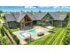 Backyard features an in-ground pool, patio, outdoor fireplace and beautiful green space at 7116 Trail Ridge Ln, Indianapolis, IN 46259
