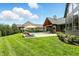 Sprawling backyard features a pool, covered outdoor living, patio space and manicured lawn at 7116 Trail Ridge Ln, Indianapolis, IN 46259