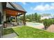 Backyard oasis with a pool, outdoor dining, comfortable seating area, and lush landscaping at 7116 Trail Ridge Ln, Indianapolis, IN 46259