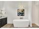 Elegant bathroom featuring a modern freestanding tub with chrome fixtures and herringbone shower at 7116 Trail Ridge Ln, Indianapolis, IN 46259