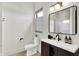 Bathroom featuring a dark wood vanity with a large mirror and modern fixtures at 7116 Trail Ridge Ln, Indianapolis, IN 46259