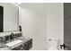 Modern powder room features granite vanity with black faucet and ample lighting at 7116 Trail Ridge Ln, Indianapolis, IN 46259