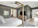 Comfortable bedroom with hardwood floors and large windows bringing in natural light at 7116 Trail Ridge Ln, Indianapolis, IN 46259
