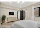 Bedroom boasts hardwood floors, a modern light fixture, and a flat screen TV at 7116 Trail Ridge Ln, Indianapolis, IN 46259