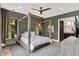 Spacious primary bedroom with four-poster bed and ensuite bathroom at 7116 Trail Ridge Ln, Indianapolis, IN 46259