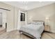 Bright bedroom features neutral tones, light hardwood floors, and an en-suite bath at 7116 Trail Ridge Ln, Indianapolis, IN 46259