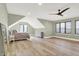 Cozy bedroom offers wood floors, neutral walls, recessed lights, a ceiling fan and natural light at 7116 Trail Ridge Ln, Indianapolis, IN 46259