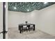 The bonus room features stylish wall paper, new carpet, and modern lighting at 7116 Trail Ridge Ln, Indianapolis, IN 46259