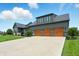 Stylish home featuring a three-car garage and attractive landscaping, providing both functionality and beauty at 7116 Trail Ridge Ln, Indianapolis, IN 46259