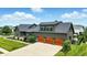 Beautiful two-story home featuring a three-car garage and lush, landscaped front yard at 7116 Trail Ridge Ln, Indianapolis, IN 46259