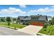 Beautiful two-story home featuring a three-car garage and lush, landscaped front yard at 7116 Trail Ridge Ln, Indianapolis, IN 46259