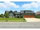 Charming home with a three-car garage, well-maintained landscaping, and a welcoming facade at 7116 Trail Ridge Ln, Indianapolis, IN 46259