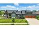 Impressive home with a three-car garage, complemented by professionally manicured landscaping at 7116 Trail Ridge Ln, Indianapolis, IN 46259
