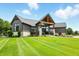 Stunning home exterior with a well-manicured lawn, striking architectural design, and inviting entrance at 7116 Trail Ridge Ln, Indianapolis, IN 46259