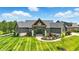 Stunning home with a modern design, beautiful landscaping, and inviting entrance at 7116 Trail Ridge Ln, Indianapolis, IN 46259