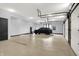 Spacious garage with epoxy flooring, featuring high ceilings and ample room for vehicle and storage at 7116 Trail Ridge Ln, Indianapolis, IN 46259