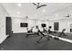 This home gym is equipped with modern equipment, mirrors and durable rubber flooring at 7116 Trail Ridge Ln, Indianapolis, IN 46259