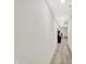 Long, bright hallway features wood floors, a stylish console table, and recessed lighting at 7116 Trail Ridge Ln, Indianapolis, IN 46259